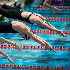 Swimmers diving into the water